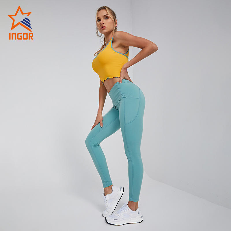 Ingorsports Fabricante de ropa deportiva personalizada Sujetador deportivo con ribete de color en contraste y conjunto de mallas de yoga con dos bolsillos laterales sin costura frontal